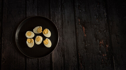 boiled eggs on dark wooden table