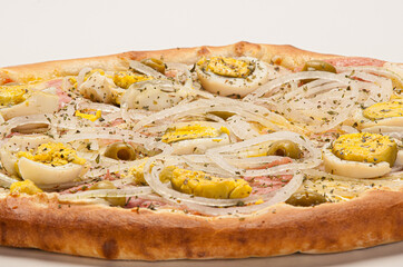 Traditional Brazilian pizza with Portuguese flavor, with mozzarella, eggs, onion, ham and olives on white background