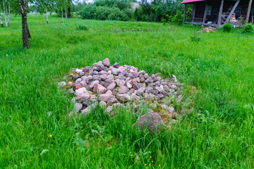 pile of rocks pebbles in green meadow