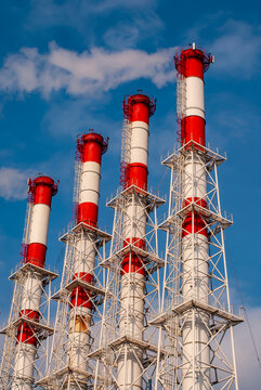 Pipes of a power plant or a plant against the blue sky.