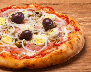 Traditional Brazilian pizza with Portuguese flavor, with mozzarella, eggs, onion, ham and olives on white background