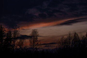 dramatatic red dark sunset over the fields and cities
