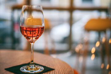 One glass of rose wine on a table in cafe