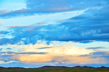 Evening cloudy sky over the sand dunes.