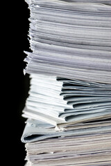 bundles bales of paper documents. stacks packs pile on the desk in the office on black background