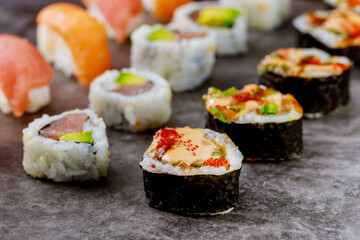 Sushi roll with raw fish on gray background. Japanese food.