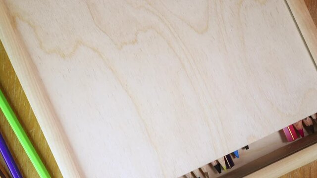 Closing wooden box with pencils