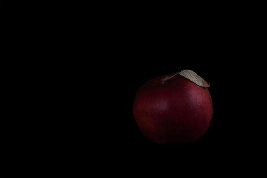 red apple isolated on black background. Image contains copy space