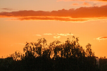 dramatatic red dark sunset over the fields and cities