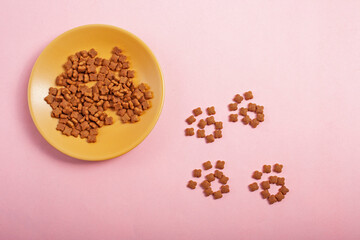 Food for cats and kittens. Horizontal orientation. On a pink background.