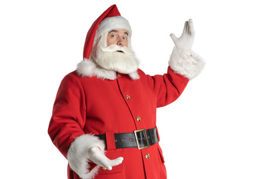 A real Santa Claus appears and indicates a greeting, isolated white background. Christmas concept.