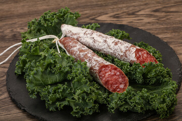 Spanish Fuet sausage with salad leaves