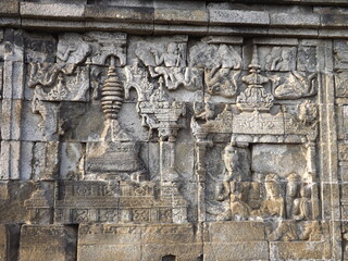 Relief panel of Borobudur temple telling about life in that era. Candi Borobudur is the largest Buddha temple located in Magelang, Central Java, Indonesia. 