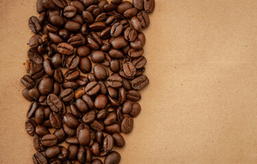 whole arabica coffee beans on a brown paper background