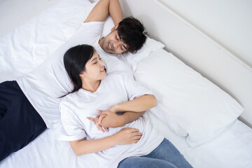 Couple Asian man and woman on bed