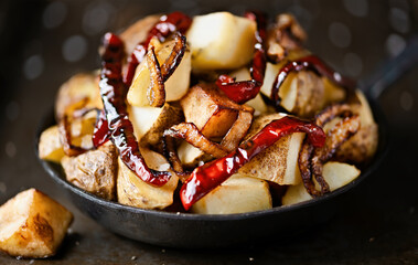 pan of spanish fried potatoes with capsicum and onions
