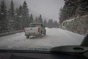 Dangerous overtaking on snowy slippery road by an SUV od pick up vehicle. SUV owners think they own the road.