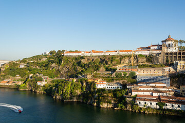 Porto, Portugal - 08/21/2019: view to the Serra do Pilar Monastery and speed boat in the Douro river.