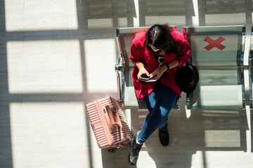 top view of woman in face mask at airport terminal