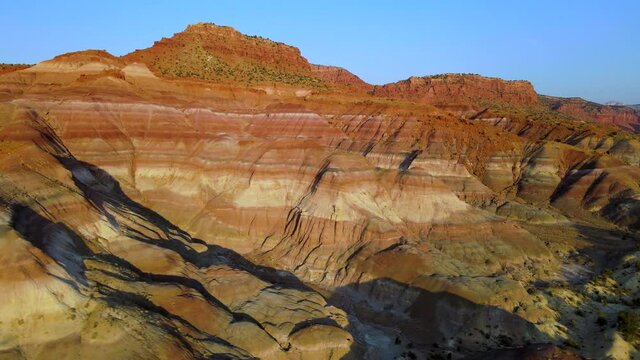 Cinematic aerial flyover of colorful sandstone strata in morning light in Southern  Utah