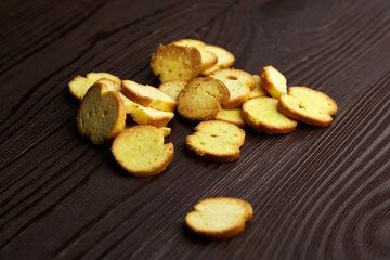 Naklejka na ściany i meble Bruschette chips, dry slices of baked bread, beer snacks scattered on wooden table