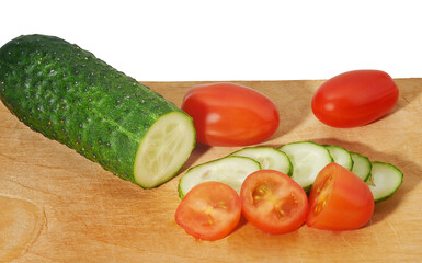 Cucumber and tomatoes on cutting board