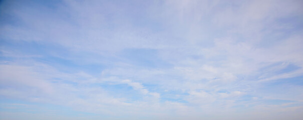 View of the blue sky with snow-white shells. Natural photo. Cloudy weather. For wallpaper, postcards and backgrounds.
