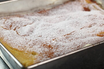 Karpatka in baking pan. Traditional Polish Cream Pie filled with pudding cream.