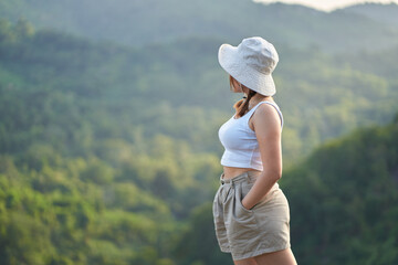 Beautiful Asian woman overlooking the nature and mountains.