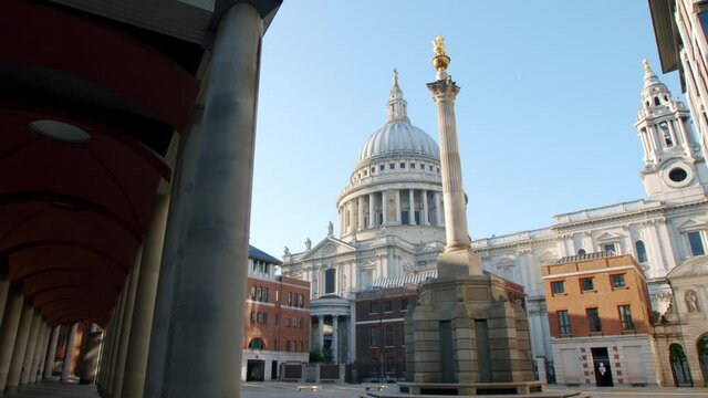 Lockdown in London, cinematic gimbal walk of beautiful St Pauls Cathedral from deserted empty Paternoster Square with blue sky's, during the coronavirus pandemic 2020.