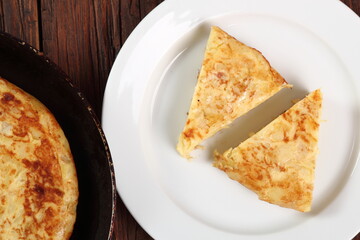 Piece of Spanish omelette on plate. Directly Above.