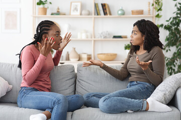 Emotional african american ladies fighting at home