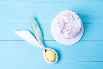 Easter cake and colorful Easter eggs close-up top view, selective focus, tinted image