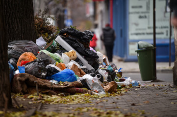 Piles of household waste are abandoned on the streets of Bucharest - 397631827