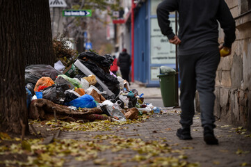 Piles of household waste are abandoned on the streets of Bucharest