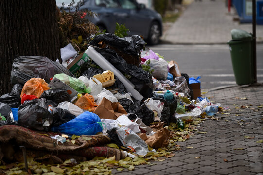 Piles of household waste are abandoned on the streets of Bucharest