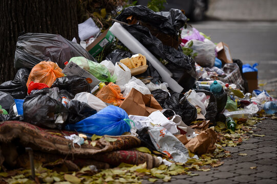 Piles of household waste are abandoned on the streets of Bucharest