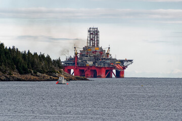 Deep water drill rig is moored near shore after finishing an exploration well, Newfoundland and...