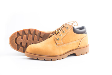 Naklejka premium Yellow nubuck leather men's boots on white background
