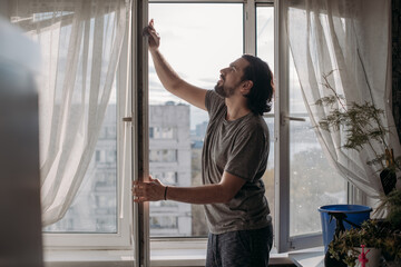 A man washes windows at home