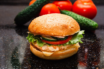 Homemade cheeseburger made from turkey. The ingredients used were poultry breast, cucumber, tomato, lettuce, cheese and sauce.
