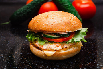 Homemade cheeseburger made from turkey. The ingredients used were poultry breast, cucumber, tomato, lettuce, cheese and sauce.
