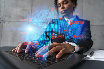 Businesswoman typing on laptop work in modern office on new project. World map drawing hologram. Double exposure. Concept of success.