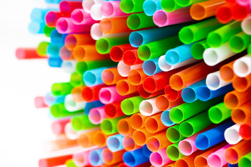 multicolored plastic tubes for cocktails on white background, closeup
