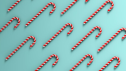 Fototapeta na wymiar Mint hard candy canes striped in Christmas colours isolated on a green background.