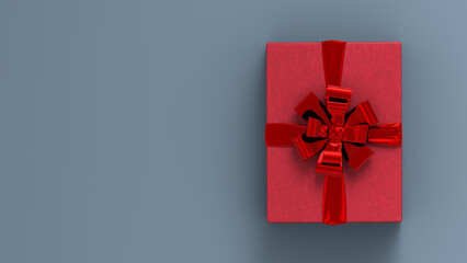 Decorative gift box with red bow and ribbon. Grey background . Copy space available for your content. Christmas gift box