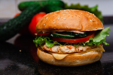 Homemade cheeseburger made from turkey. The ingredients used were poultry breast, cucumber, tomato, lettuce, cheese and sauce.
