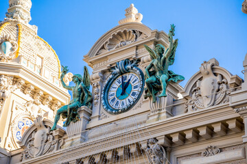 Monte-Carlo, Monaco 29.11.2020 Clock With Bronze Sculptures Of Angels Above The Main Entrance Of Monte-Carlo Casino In Monaco, Europe. High quality photo