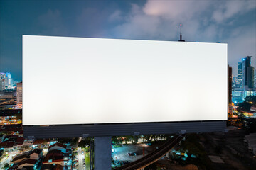 Blank white road billboard with KL cityscape background at night time. Street advertising poster, mock up, 3D rendering. Front view. The concept of marketing communication to promote or sell idea.