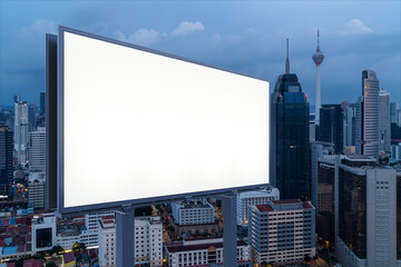 Blank white road billboard with KL cityscape background at night time. Street advertising poster,...
